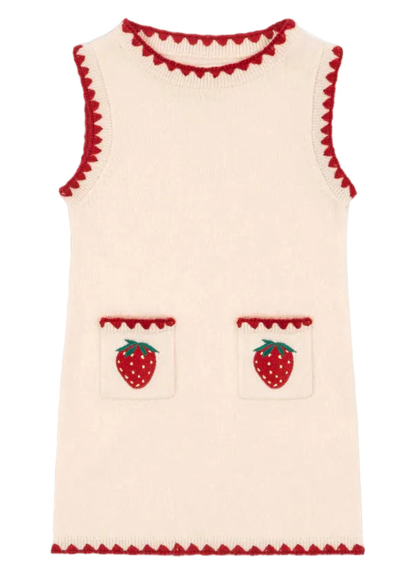 The Girls' Collette Dress by Konges Slojd is a sleeveless, cream knitted wool dress with a fitted silhouette, red trim, and two front pockets adorned with charming strawberry embroidery.