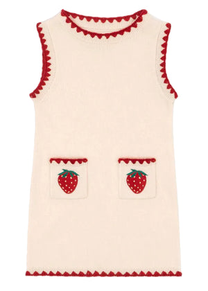 The Girls' Collette Dress by Konges Slojd is a sleeveless, cream knitted wool dress with a fitted silhouette, red trim, and two front pockets adorned with charming strawberry embroidery.