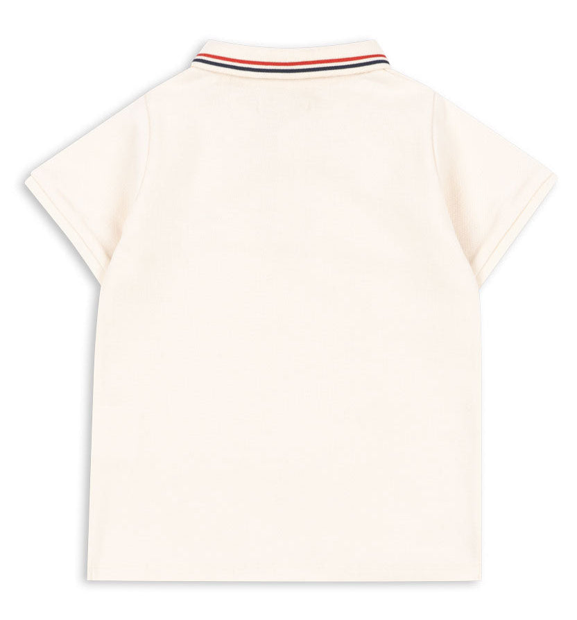 Back view of the Konges Slojd Baby Boys’ and Boys’ Florian Polo Shirt, a cream short-sleeve style with a regular collar and button placket, featuring ribbed edging decorated with red, navy, and white stripes.