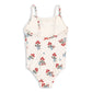 The Konges Slojd Baby Girls’ and Girls’ Frago Swimsuit features a cream base adorned with red strawberries, green leaves, blue dots, and a delicate red bow at the neckline. Designed for comfort and flexibility, this one-piece swimsuit ensures your little one can move freely during hours of play.