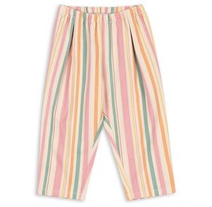 The Konges Slojd Baby Girls’ and Girls’ Frankie Pants, made from organic cotton twill, feature an elastic waistband and vertical pastel stripes in pink, yellow, orange, green, and white. The pants are shown laid flat on a white background.