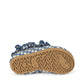 The Fresia Frill Swim Shoes by Konges Slojd are shown from the bottom, highlighting their tan rubber sole with textured patterns and engraved designs; these quick-drying blue and white gingham sandals seamlessly combine style and comfort for your next poolside adventure.
