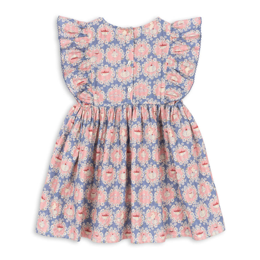 The Baby Girls’ and Girls’ Kim Frill Dress by Konges Slojd is a charming summer dress for children, featuring ruffled sleeves and a pink and blue floral pattern, shown here from the back.