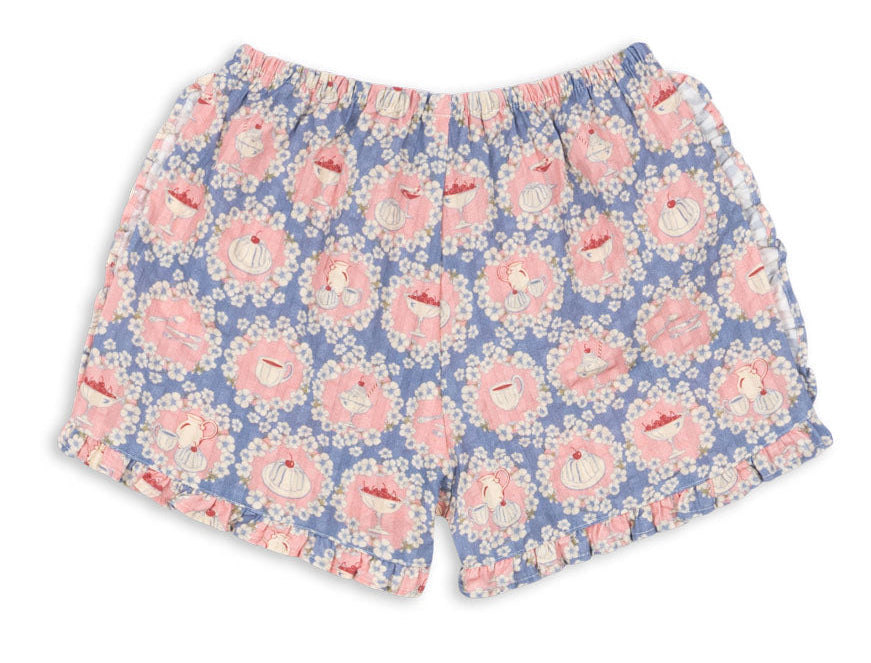 Baby girls’ and girls’ Kim Frill Shorts by Konges Slojd, featuring a light blue organic cotton fabric decorated with a pink and white cupcake print and finished with white frilled trim along the hem for breathable comfort all night long.
