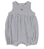 The Baby Kim Romper by Konges Slojd features a sleeveless design in a blue and white checkered seersucker fabric, a gathered waist, delicate elastic cuffs for extra comfort, snap buttons at the bottom, and is adorned with a small embroidered yellow flower.