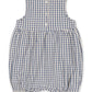 The Konges Slojd Baby Kim Romper is a sleeveless seersucker romper for babies, showcasing a charming blue and white plaid pattern, gathered waist, elasticized leg openings, and three snap buttons on the back.