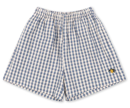 Baby boys’ and boys’ Kim Short by Konges Slojd, featuring a blue and white checkered design, crafted from breathable organic cotton with an elastic waistband and a small yellow embroidered detail on the lower right leg, laid flat on a white background.