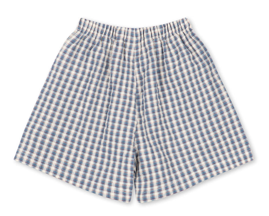 Baby Boys’ and Boys’ Kim Shorts by Konges Slojd, featuring a blue and white checkered pattern with an elastic waistband, crafted from breathable organic cotton for all-day comfort, displayed flat on a white background.