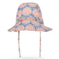 The Konges Slojd Baby Girls’ and Girls’ Kim Sun Hat is a wide-brimmed bucket hat with chin straps, featuring a soft blue background adorned with pink floral prints and small white flowers. Designed for comfort and style, this sun hat provides extra coverage to protect your little one from the sun.