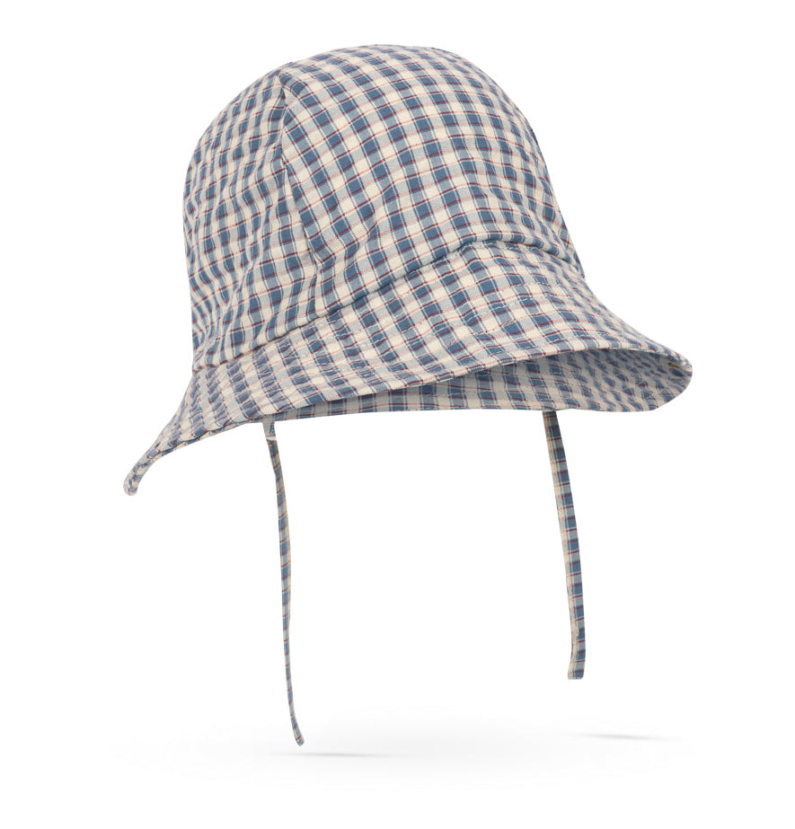 The Konges Slojd Baby Boys’ and Boys’ Sun Hat, featuring a blue and beige plaid organic cotton design with a wide brim and chin straps, is shown against a white background.