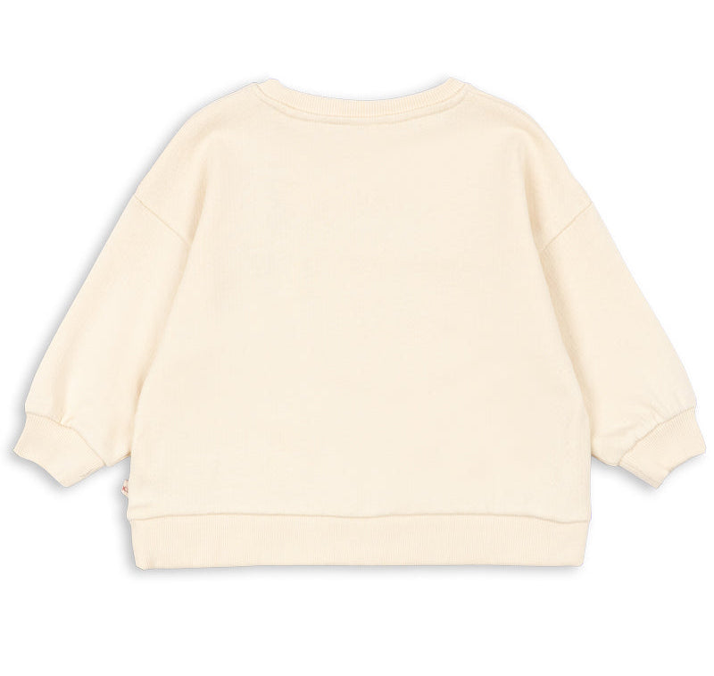 The Kids’ Loupy Lou Sweatshirt by Konges Slojd is shown from the back in a cream color, featuring long sleeves with ribbed cuffs, waistband, and crewneck collar. Laid flat against a white background, this sweatshirt is crafted from soft cotton fabric for comfort and durability.