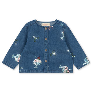 The Konges Slojd Girls’ Magot Sequin Denim Jacket is a long-sleeved children’s shirt jacket featuring front buttons and colorful sequined designs of various animals, embroidered motifs, and playful figures like a sparkling sequin ice cream.