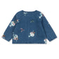 The Girls’ Magot Sequin Denim Jacket by Konges Slojd is a blue long-sleeve denim shirt jacket adorned with multicolored sequin appliqué bows, round shapes, and playful embroidered motifs scattered across the fabric.