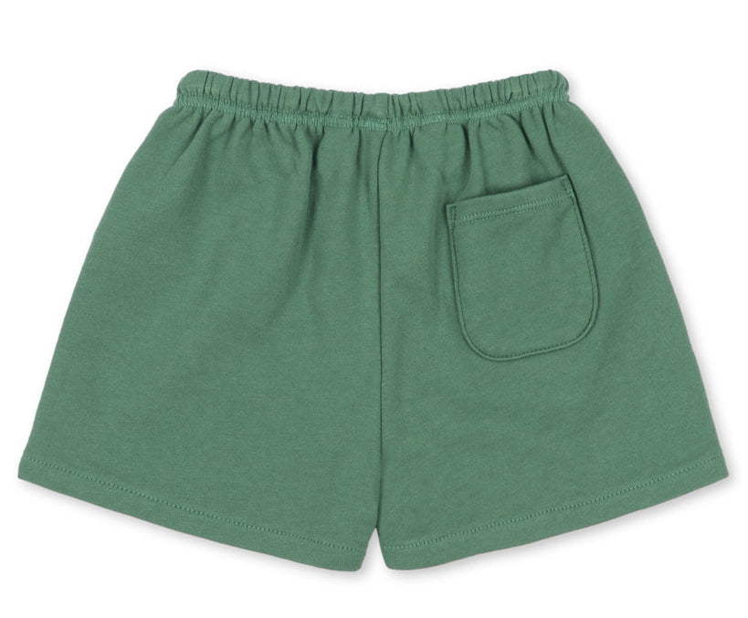 Baby boys’ and boys’ Spotty Sweat Short by Konges Slojd, featuring an elastic waistband and a single patch pocket on the back, laid flat on a white background.