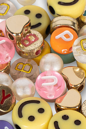 The ABC Jewelery Set by Konges Slojd features assorted colorful beads, smiley faces, letter pearls, and metallic accents—ideal for jewellery making.
