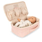 The Baby Doll Nursery Suitcase by Konges Slojd features a pink and white checked case with a soft doll and lid pockets for nursery accessories, perfect for imaginative play.