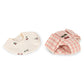 The Konges Slojd Baby Doll Nursery Suitcase features a cream cherry bib and a pink plaid bonnet—ideal accessories for imaginative doll play, displayed flat on a white background.