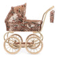 Sparkly Minnie Doll Pram with a foldable sun canopy, covered in rose gold sequins and a red cherry pattern, featuring a light tan frame and large wheels.