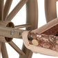 Close-up of a Konges Slojd Sparkly Minnie Doll Pram, featuring a vintage-style frame, brown plastic wheels, and a seat covered in metallic sequin fabric.
