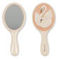 Front and back views of the Konges Slojd Swan Beauty Set hand mirror: one side reflective, the other with a raised swan on peach. Perfect for imaginative play.