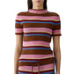 A woman wears the Guest in Residence Palazzo Top, a short-sleeve ribbed knit mock neck featuring horizontal stripes in brown, pink, blue, and yellow.