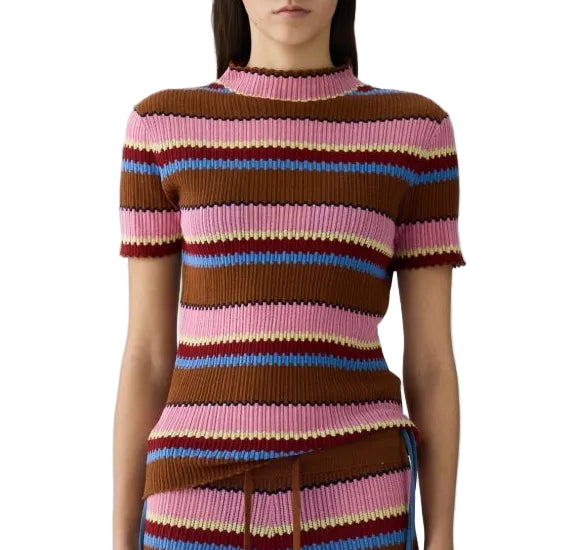 A woman wears the Guest in Residence Palazzo Top, a short-sleeve ribbed knit mock neck featuring horizontal stripes in brown, pink, blue, and yellow.