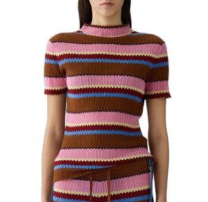 A woman wears the Guest in Residence Palazzo Top, a short-sleeve ribbed knit mock neck featuring horizontal stripes in brown, pink, blue, and yellow.