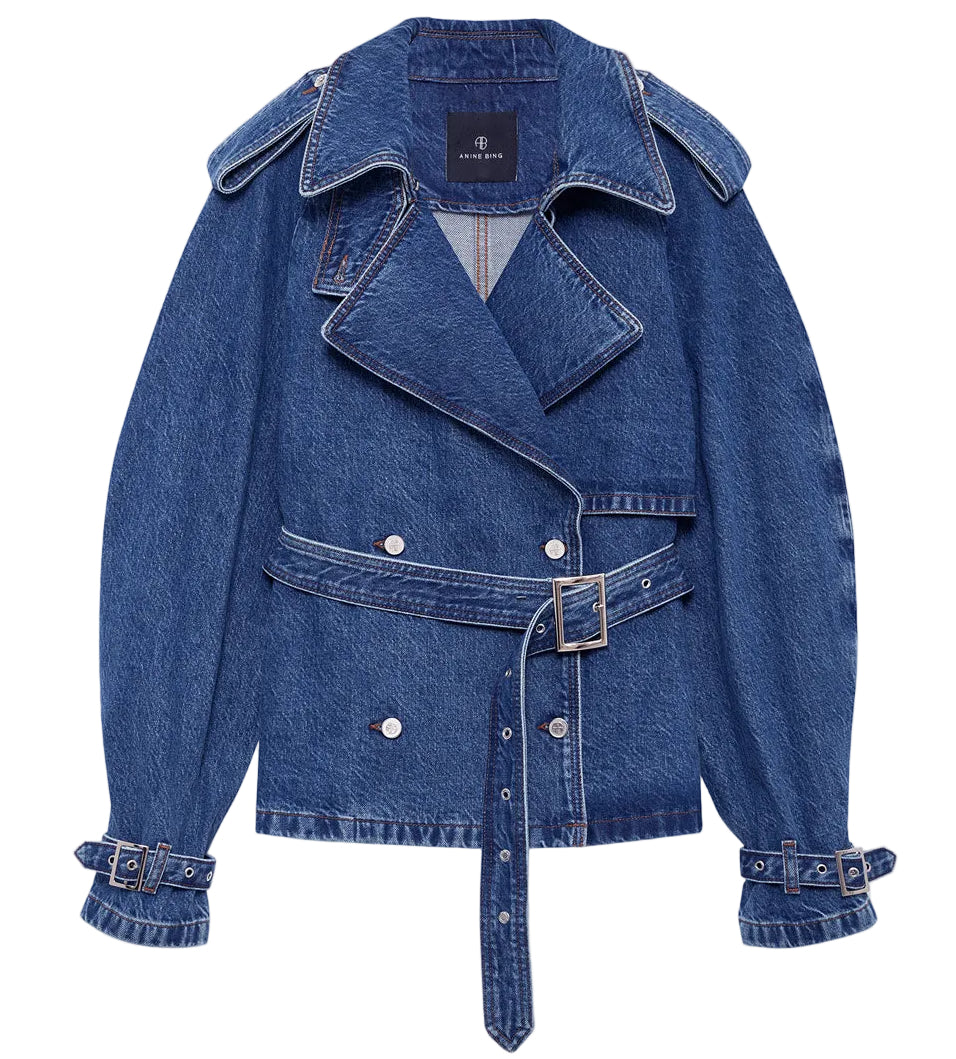 The Pascale Trench by Anine Bing is a blue denim belted jacket with silver buttons, wide lapels, and adjustable sleeve cuffs, shown laid flat on a white background.