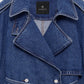 Close-up of the Pascale Trench by Anine Bing, a blue denim, military-inspired trench coat featuring wide lapels, silver buttons, a buckle belt, and a black ANINE BING label on the collar.