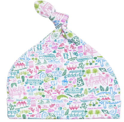 Discover the Joy Street Palm Beach Baby Hat, a vibrant accessory with a knotted top adorned with playful illustrations of animals, plants, and buildings in pink, blue, and green—ideal for sunny days.