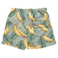 Pink Chicken Boys' Swim Trunks feature a vibrant green banana leaves and banana print, an elastic waistband, and a convenient back pocket.