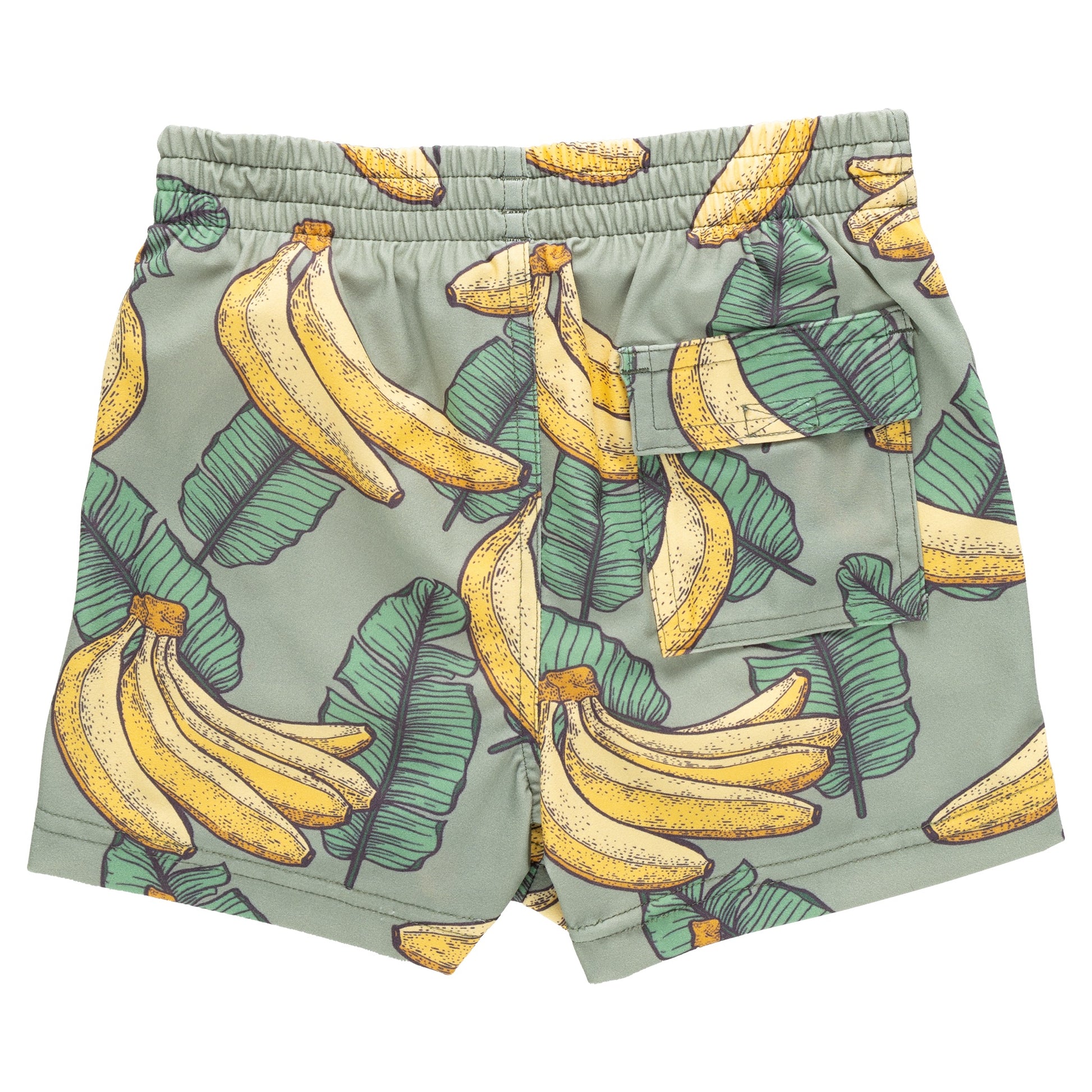 The Pink Chicken Baby Boys' Swim Trunk features a playful banana and green leaf pattern, an elastic waist, and a convenient back pocket—ideal for beach vacations.