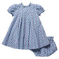 Pink Chicken Baby Girls’ Lucia Dress Set in light blue, featuring short puff sleeves and a delicate floral print, adorned with exquisite diamond smocking that highlights heritage craftsmanship. The set includes matching bloomers and is displayed on a white background.
