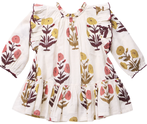 The Girls’ Harper Dress by Pink Chicken features a white long-sleeve design with a ruffled hem and Harvest Dandelion floral print in yellow, pink, and brown.