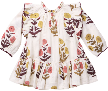 The Girls’ Harper Dress by Pink Chicken features a white long-sleeve design with a ruffled hem and Harvest Dandelion floral print in yellow, pink, and brown.