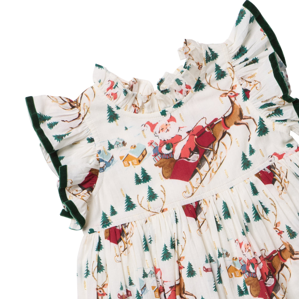 Pink Chicken Girls’ Jennifer Dress in cream featuring a Santa sleigh, evergreen tree, and house print with dark green velvet trim on the ruffle sleeves and neckline.
