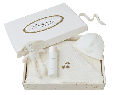 The Bonpoint Baby Bath Set includes newborn essentials: a plush bunny toy, skincare bottle, white baby hat, and hooded towel, all beautifully presented in a branded white box—an ideal gift for baby bath time.