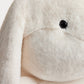 Close-up of the XXL Signature Rabbit by Bonpoint, an extra-large plush stuffed animal featuring cream-colored fur, a black plastic eye, and a floppy ear—this cuddly toy embodies the charm of the iconic Bonpoint bunny.