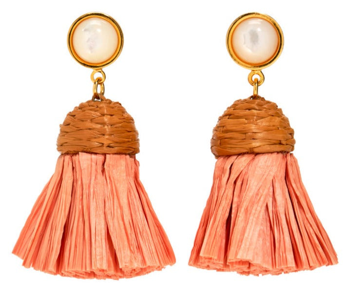 The Lizzie Fortunato Raffia Earrings by Lizzie Fortunato are gold-plated, featuring gold-tone round tops with mother-of-pearl centers and pink tassels hanging from woven brown caps.