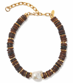 The Lizzie Fortunato Bilbao Collar II features dark brown recycled bone heishi beads, gold discs, a baroque freshwater pearl centerpiece, and a gold adjustable chain clasp.
