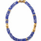 The Lizzie Fortunato Toga Beach Necklace features round cobalt-blue recycled glass beads, gold cylinder accents, and a freshwater pearl detail by the clasp.