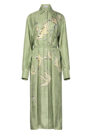 The Floyd Dress by Altuzarra is a light green shirt dress featuring a point collar, button front, wrap tie waist, and an abstract beige bird print with dark outlines.