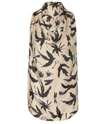 A sleeveless beige cape with a black bird and chain pattern, shown from the back, layered over the Altuzarra Sleary Top for effortless sophistication.