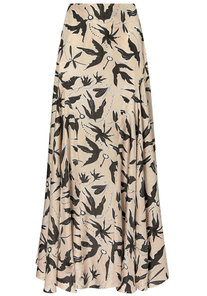 The Elton Skirt by Altuzarra is a beige midi skirt with a fitted waist, flared silhouette, and a black bird and floral print pattern.