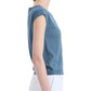 A woman in profile wears the Altuzarra Rinaldi Top, a blue gathered-shoulder style, paired with white pants against a plain background.