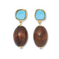 The Olea Earrings by Lizzie Fortunato feature irregular imitation turquoise stones atop large oval brown wooden beads, all gold-plated and shown against a white background.