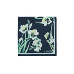 The Erdem Floral Print Silk Twill Scarf features navy blue silk with white and green florals, "ERDEM" in one corner, and is a timeless accessory from the brand’s Pre Fall 2026 collection.