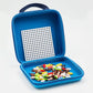The Plus Plus Travel Case features a white perforated board and colorful interlocking pieces, making it ideal for creative play anywhere.