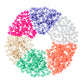 The Plus Plus Tube - 240 Piece - Pearl Mix features small interlocking pieces in pink, purple, white, orange, green, and beige on a white background—ideal for creative STEM play and building fine motor skills.