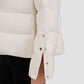 Close-up of a white Herno Cashmere Silk Jacket sleeve, featuring an eco-friendly, water-repellent quilted design with a side slit and snap button closures.